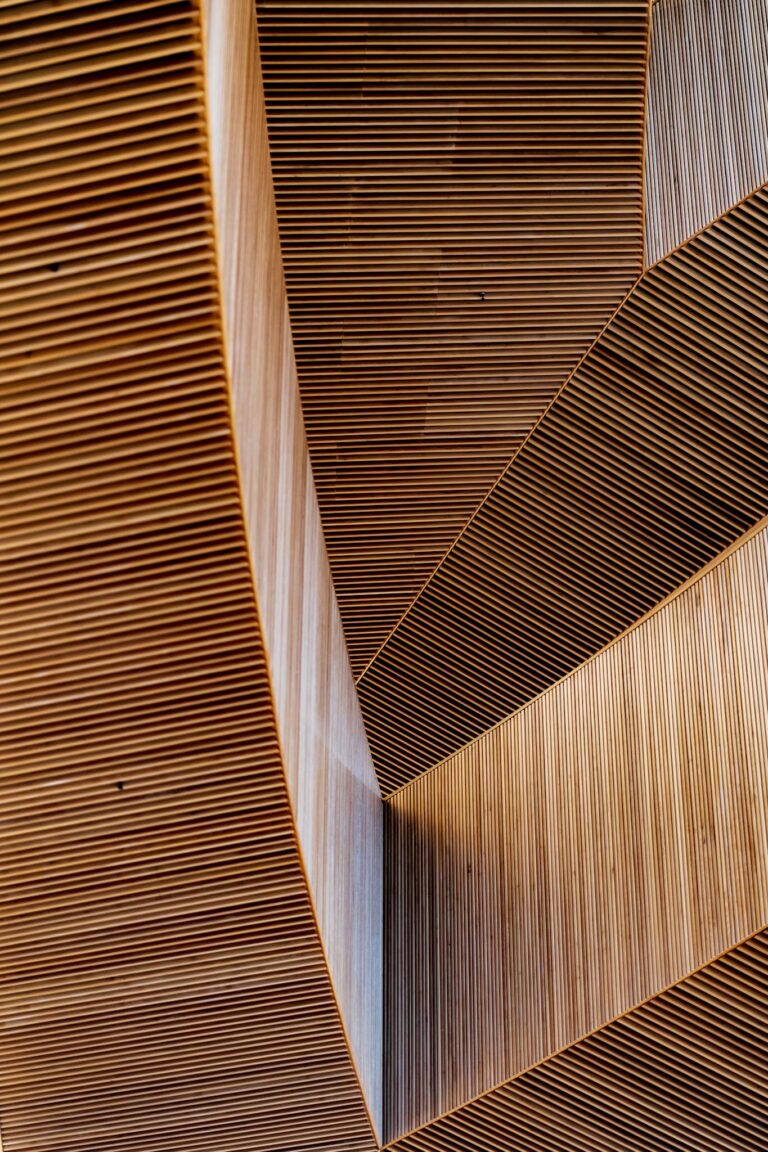 Vertical shot displaying intricate modern wooden structures with abstract shapes and patterns.